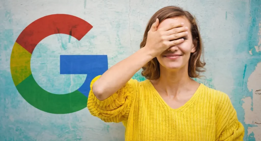 Femme souriante en pull jaune cachant son visage, avec le logo Google en arrière-plan sur un mur coloré.