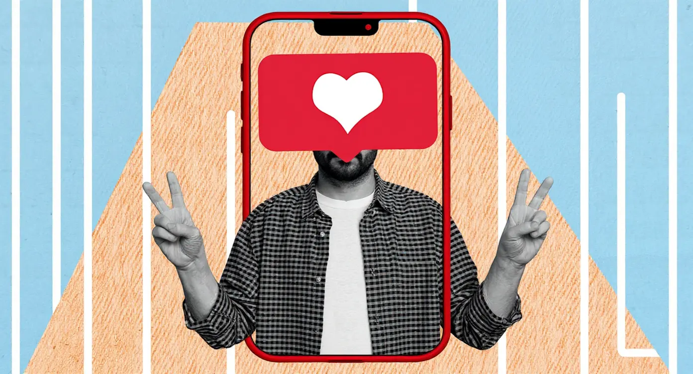 Homme faisant un signe de paix à travers un smartphone avec une icône de cœur, symbole de l'amour numérique.